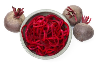 Photo of Raw beetroot noodles and fresh vegetables isolated on white, top view. Vegetarian dish