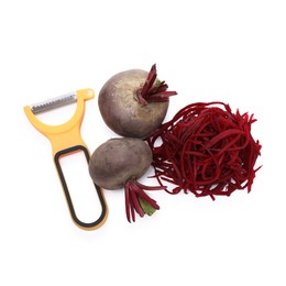 Photo of Raw beetroot noodles, fresh vegetables and peeler isolated on white, top view. Vegetarian dish