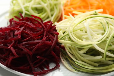 Photo of Different vegetable noodles on plate, closeup. Vegetarian dish