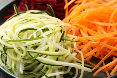 Photo of Different vegetable noodles on plate, closeup. Vegetarian dish
