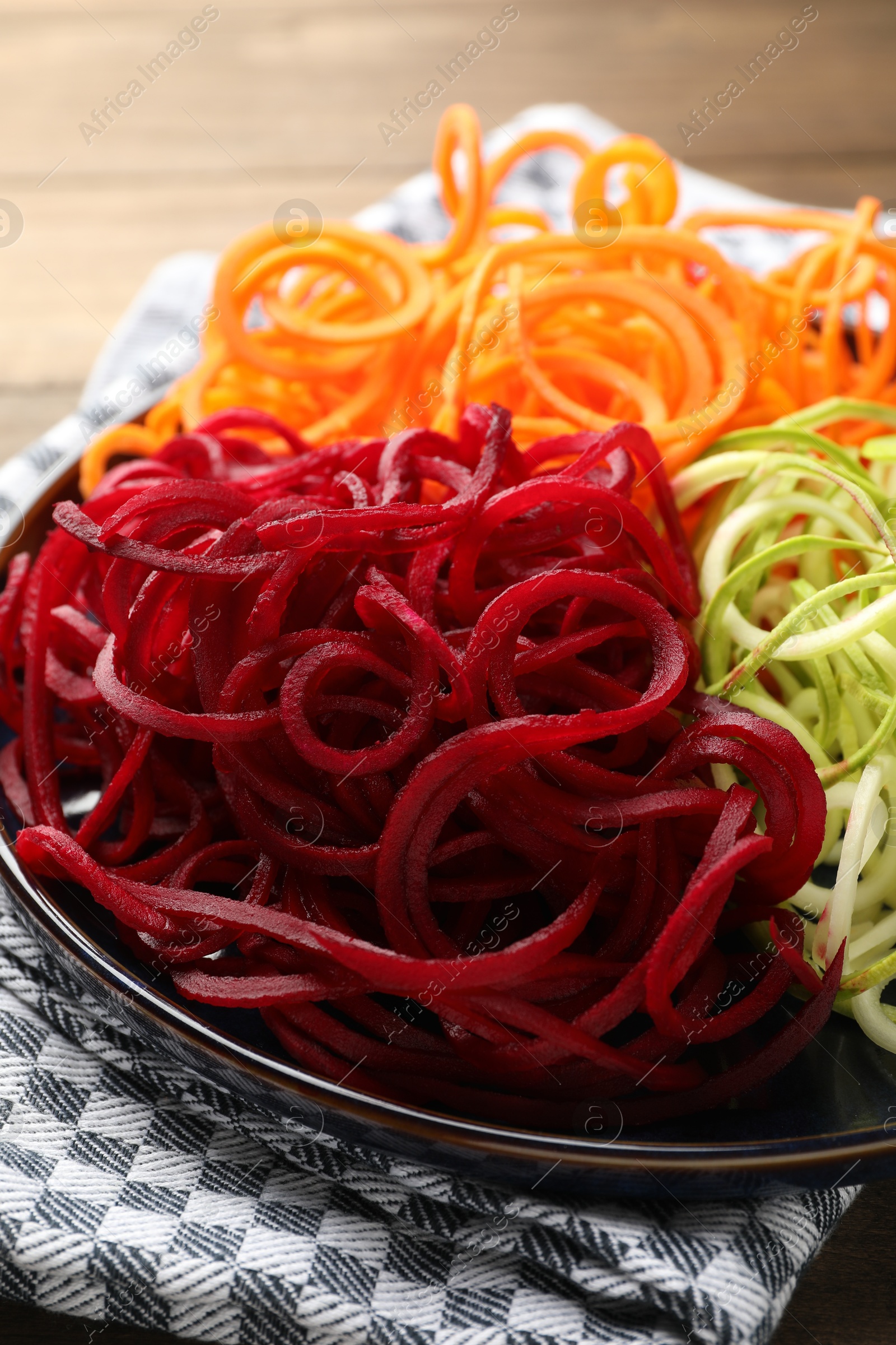 Different vegetable noodles on table, closeup. Vegetarian dish Photo of Different vegetable noodles on table, closeup. Vegetarian dish