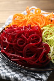 Photo of Different vegetable noodles on table, closeup. Vegetarian dish