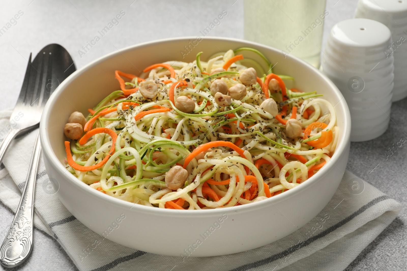 Tasty vegetable noodles with chickpeas served on grey table, closeup. Vegetarian dish Photo of Tasty vegetable noodles with chickpeas served on grey table, closeup. Vegetarian dish