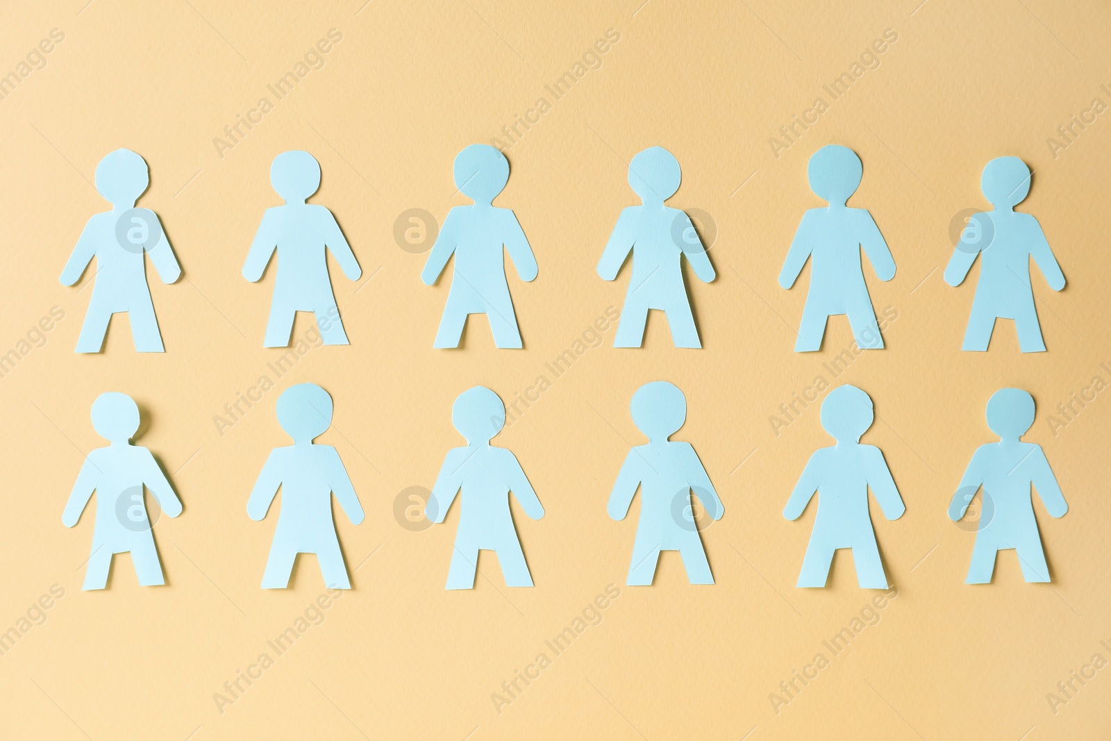Paper human figures on beige background, flat lay Photo of Paper human figures on beige background, flat lay