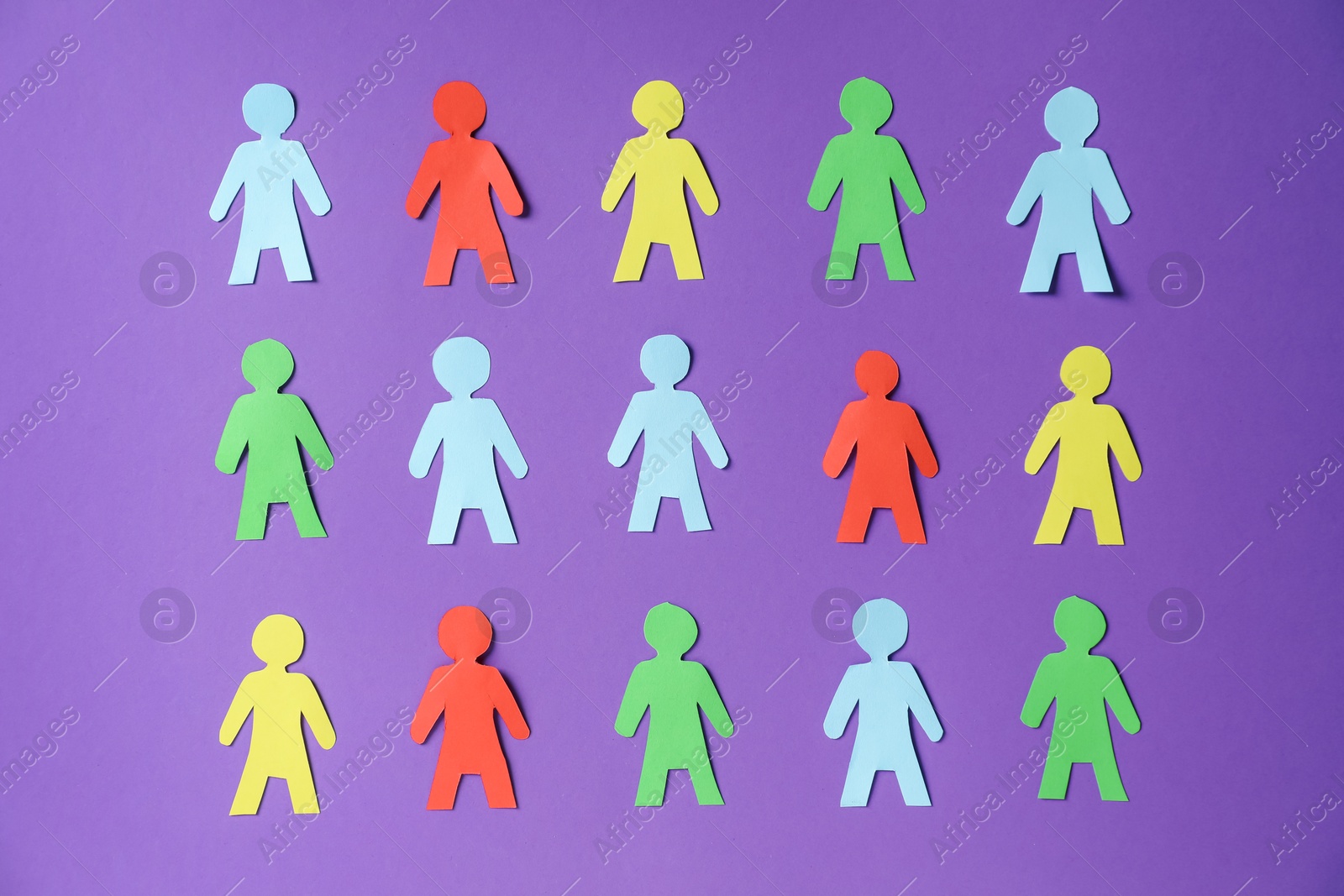 Photo of Paper human figures on purple background, flat lay