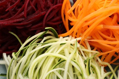 Photo of Different vegetable noodles as background, closeup. Vegetarian dish
