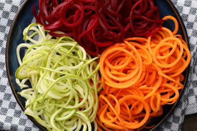 Photo of Different vegetable noodles on table, top view. Vegetarian dish