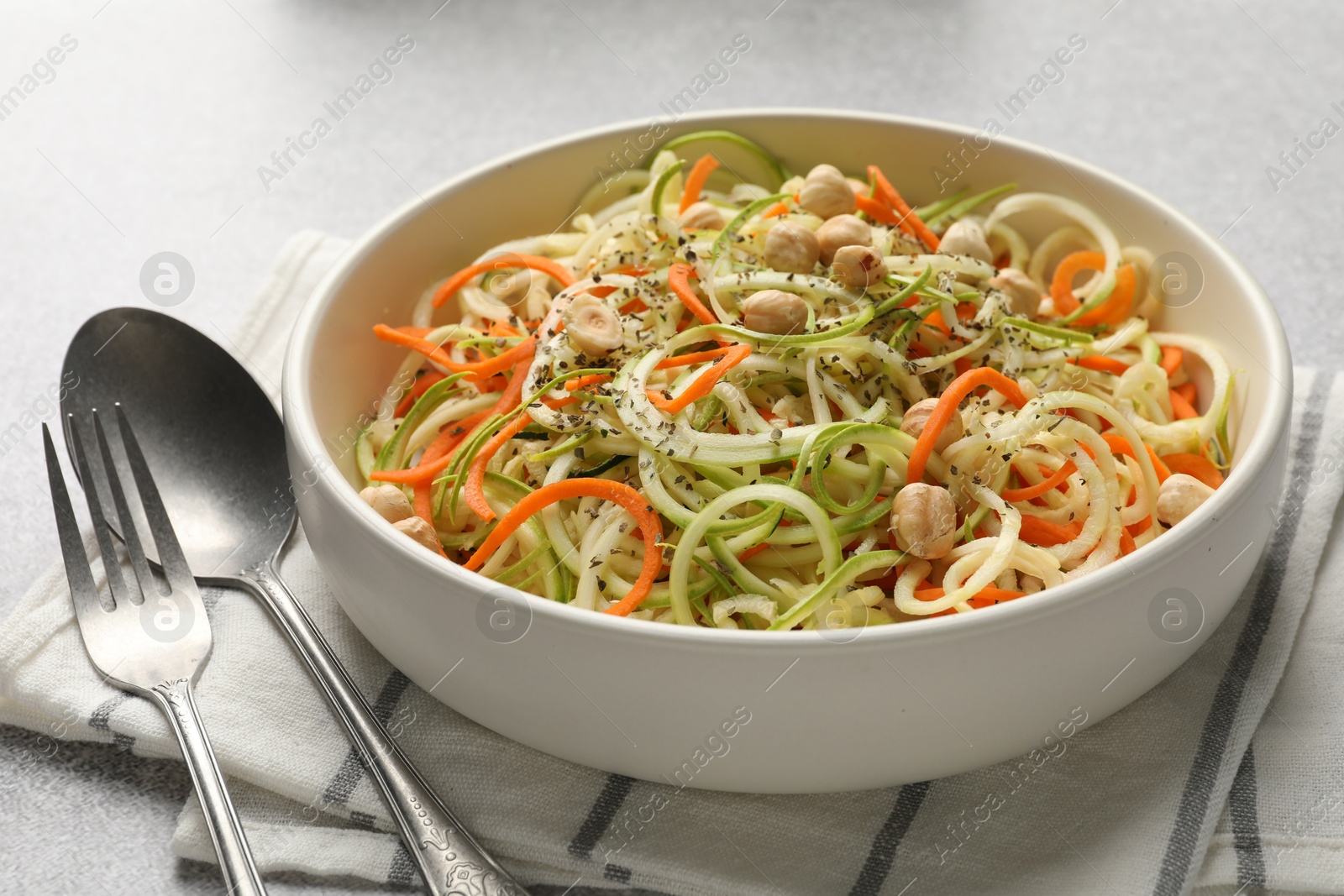 Tasty vegetable noodles with chickpeas served on grey table, closeup. Vegetarian dish Photo of Tasty vegetable noodles with chickpeas served on grey table, closeup. Vegetarian dish