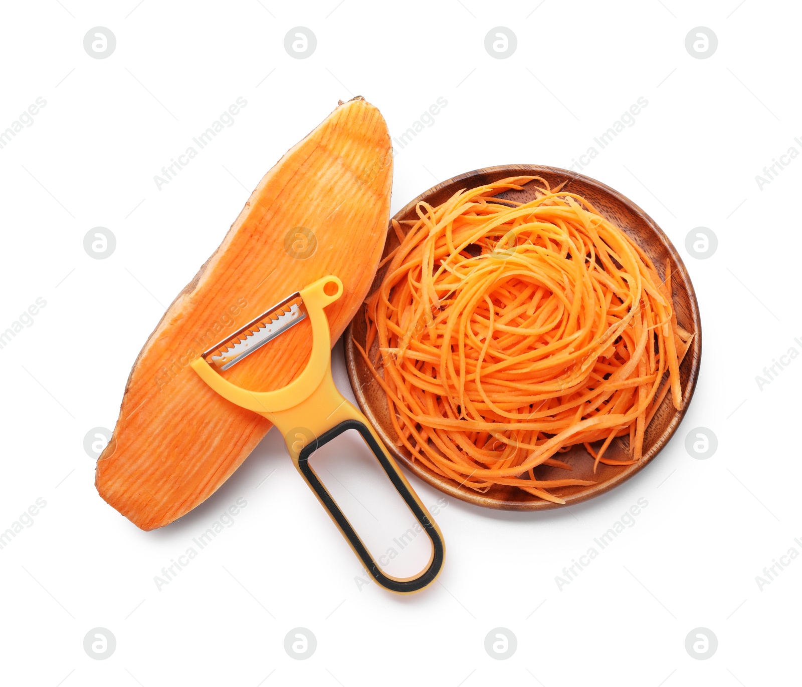 Photo of Vegetable noodles, sweet potato and peeler isolated on white, top view