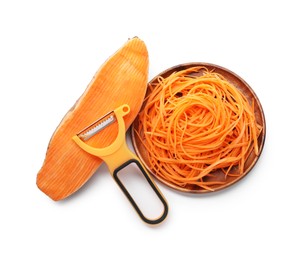 Photo of Vegetable noodles, sweet potato and peeler isolated on white, top view