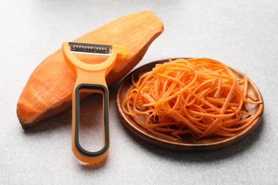 Photo of Vegetable noodles, sweet potato and peeler on light table