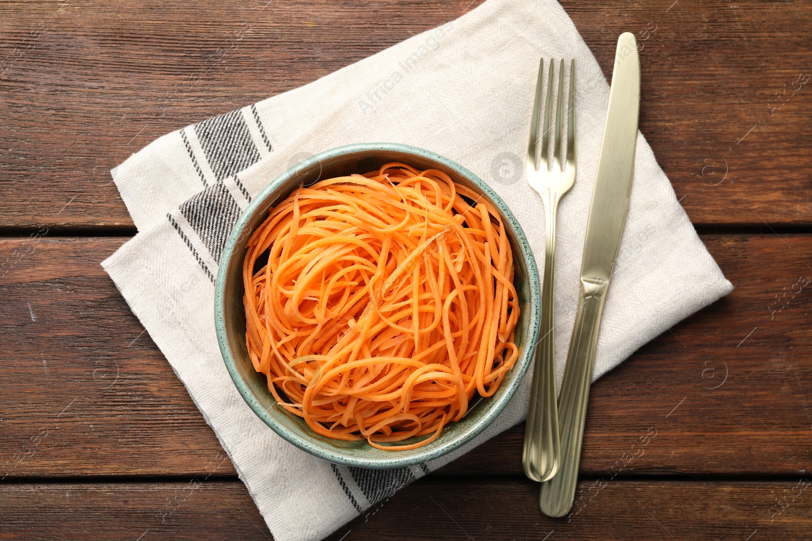 Photo of Vegetable noodles served on wooden table, top view