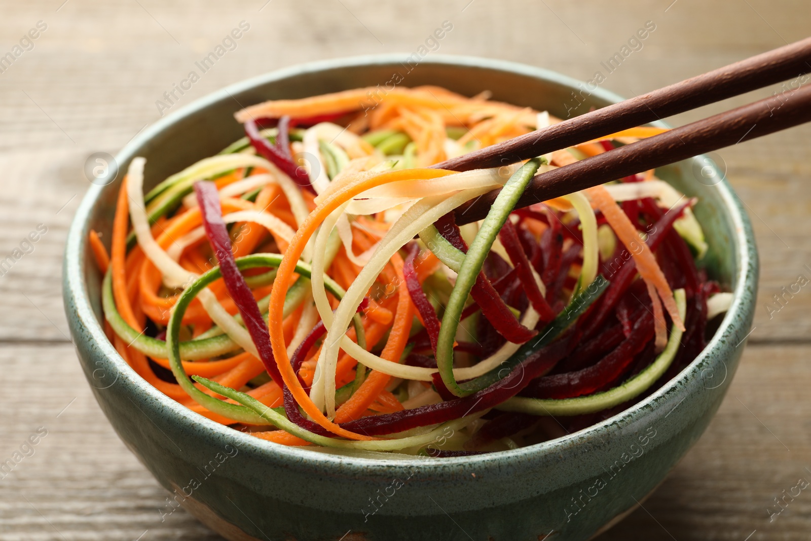 Tasty vegetable noodles served on wooden table, closeup Photo of Tasty vegetable noodles served on wooden table, closeup