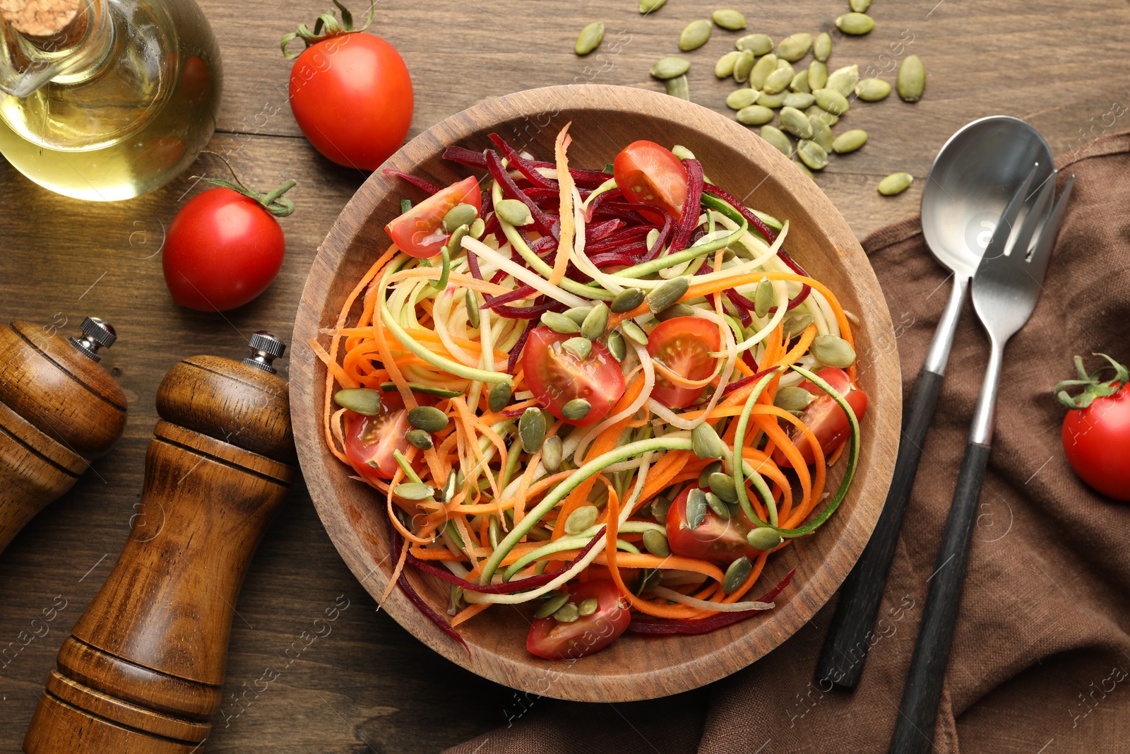 Photo of Tasty vegetable noodles served on wooden table, flat lay