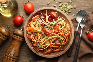 Photo of Tasty vegetable noodles served on wooden table, flat lay
