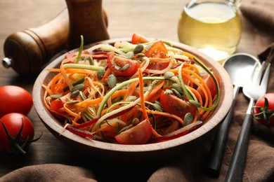 Photo of Tasty vegetable noodles served on wooden table, closeup