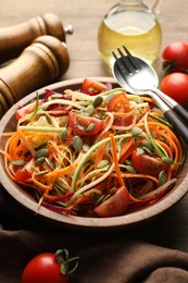 Photo of Tasty vegetable noodles served on wooden table, closeup