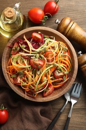 Photo of Tasty vegetable noodles served on wooden table, flat lay