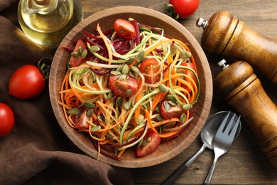 Photo of Tasty vegetable noodles served on wooden table, flat lay
