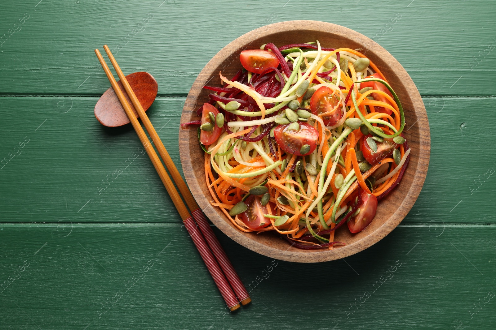 Tasty vegetable noodles served on green wooden table, top view Photo of Tasty vegetable noodles served on green wooden table, top view