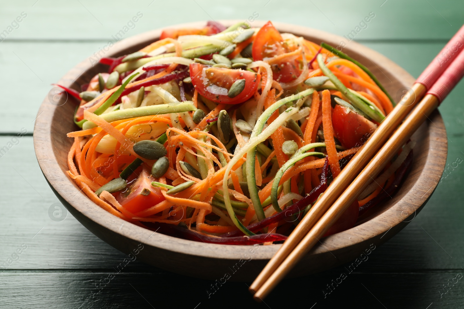 Tasty vegetable noodles served on green wooden table, closeup Photo of Tasty vegetable noodles served on green wooden table, closeup