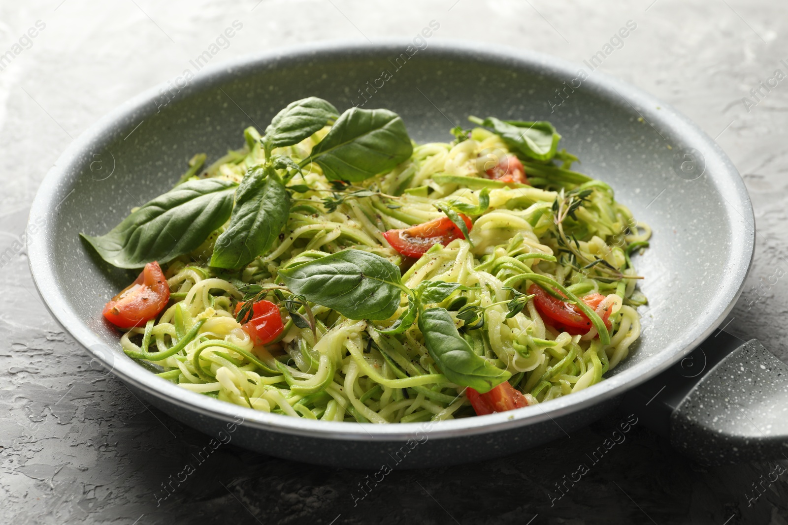 Tasty zucchini noodles with tomatoes and basil Photo of Tasty zucchini noodles with tomatoes and basil