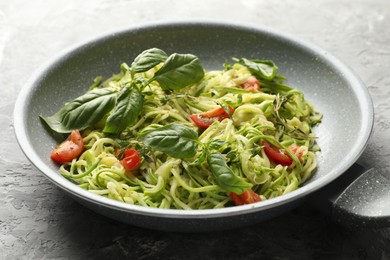 Photo of Tasty zucchini noodles with tomatoes and basil