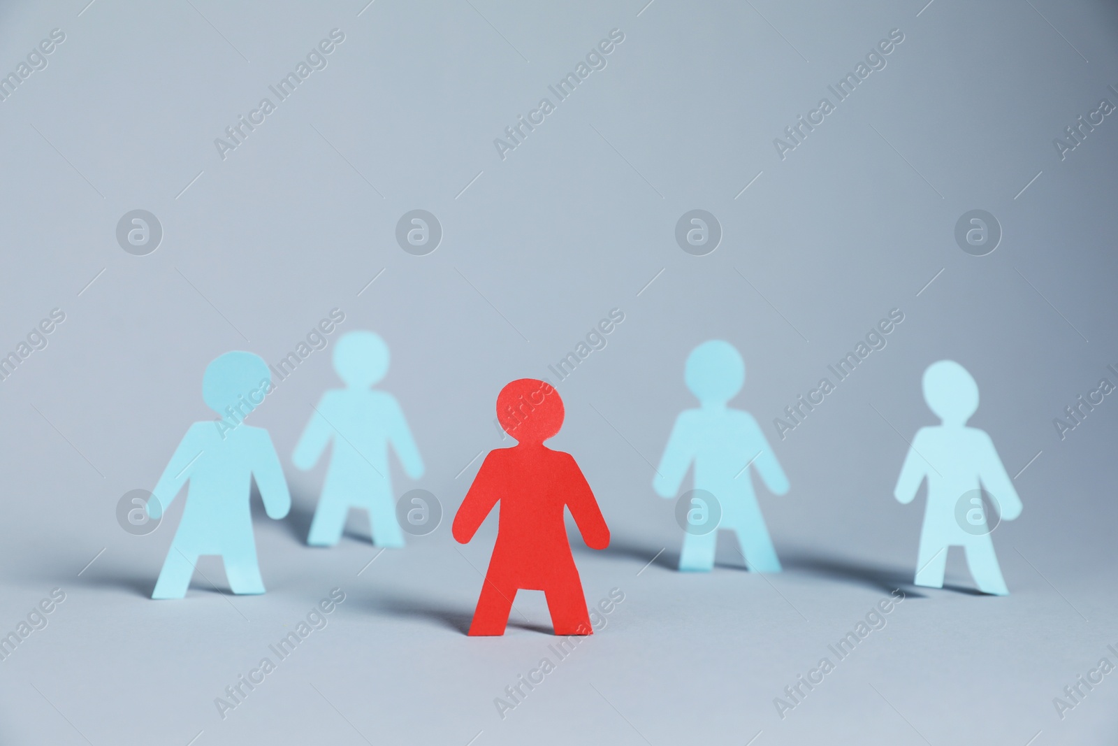 Many human paper figures on light background Photo of Many human paper figures on light background