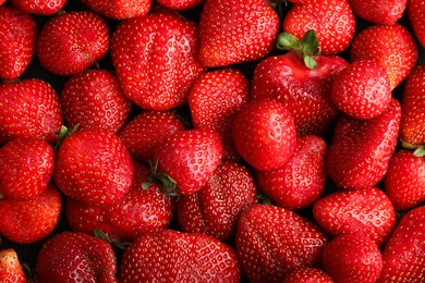 Photo of Fresh ripe strawberries as background, top view