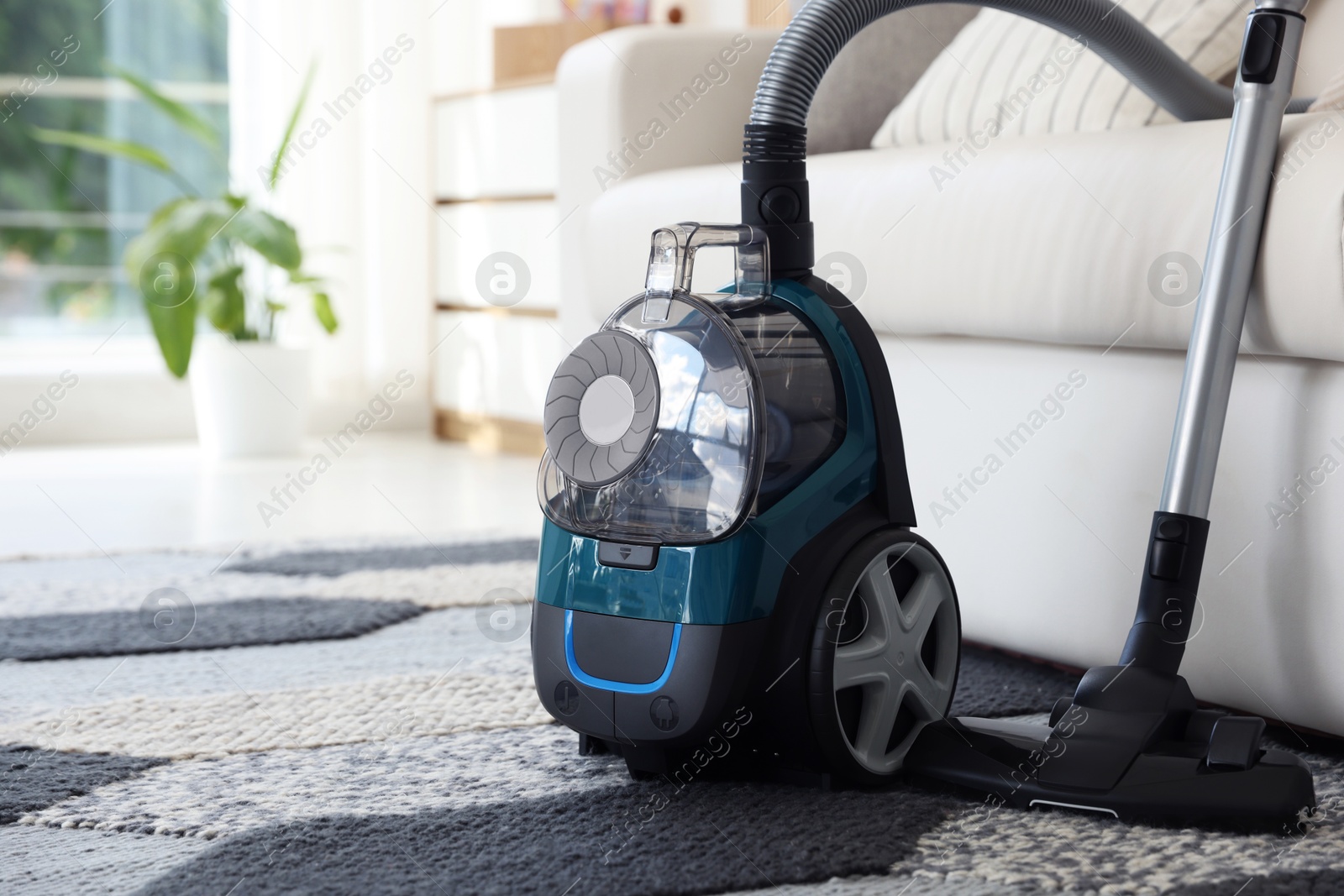 One vacuum cleaner on floor indoors. Household appliance Photo of One vacuum cleaner on floor indoors. Household appliance