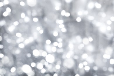 Image of Blurred shiny silver background with sparkling glitter, bokeh effect