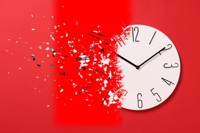 Image of Time running out. Clock dissolving on red background