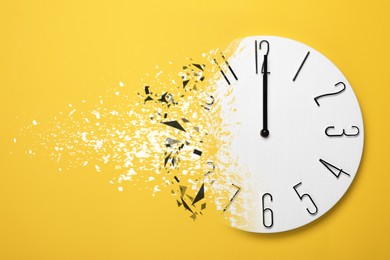 Image of Time running out. Clock dissolving on orange background