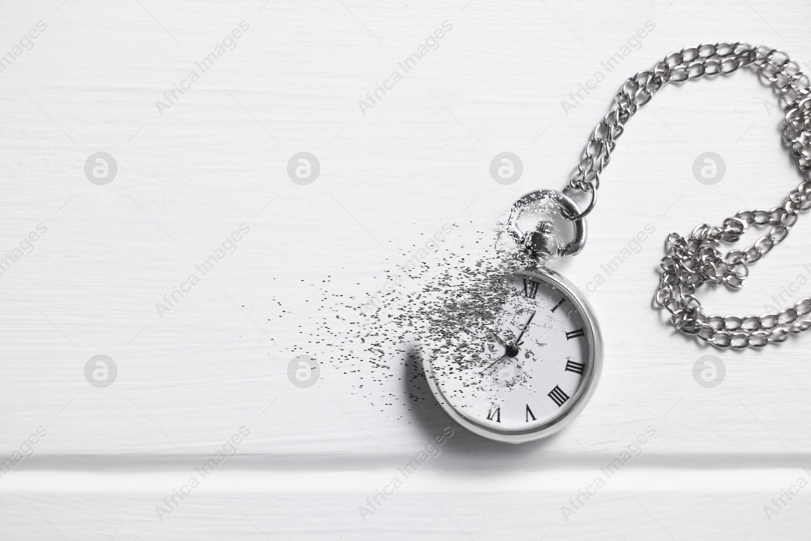 Time running out. Pocket watch dissolving on white table, top view Image of Time running out. Pocket watch dissolving on white table, top view