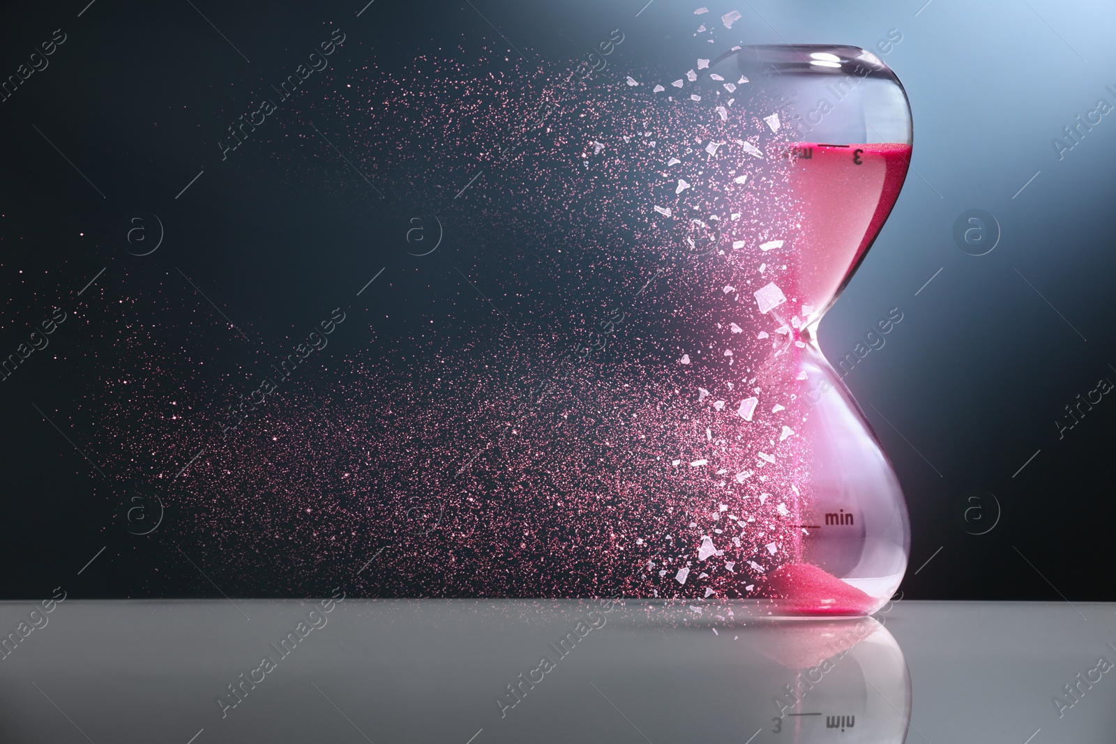 Image of Time running out. Hourglass dissolving on table against dark background