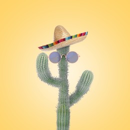 Image of Cactus with sunglasses and sombrero hat against pale orange background