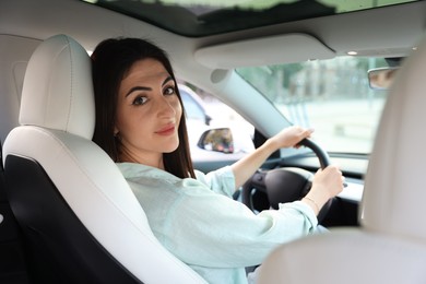 Photo of Woman holding steering wheel while driving car