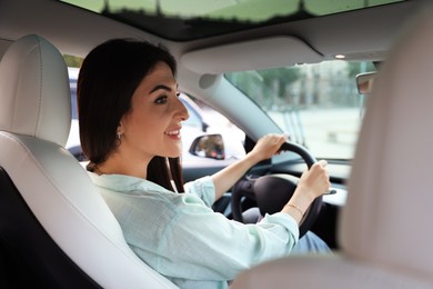 Photo of Woman holding steering wheel while driving car