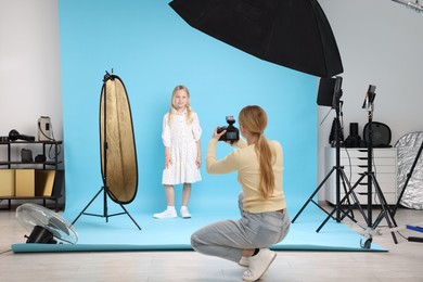 Photo of Photographer working with model in professional photo studio