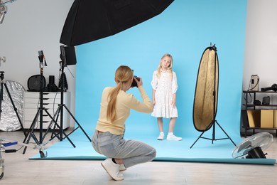 Photo of Photographer working with model in professional photo studio