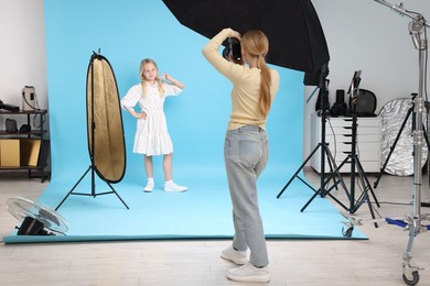 Photo of Photographer working with model in professional photo studio