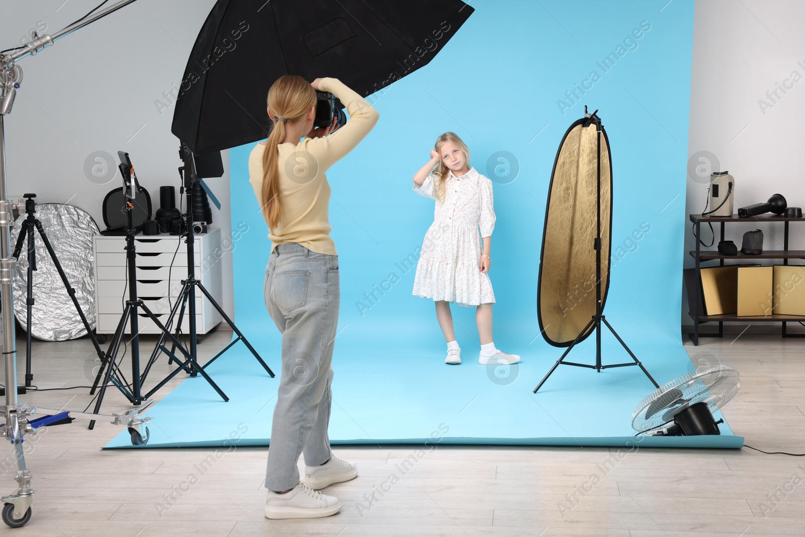 Photographer working with model in professional photo studio Photo of Photographer working with model in professional photo studio