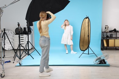 Photo of Photographer working with model in professional photo studio