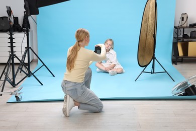 Photo of Photographer working with model in professional photo studio