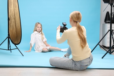 Photo of Photographer working with model in professional photo studio