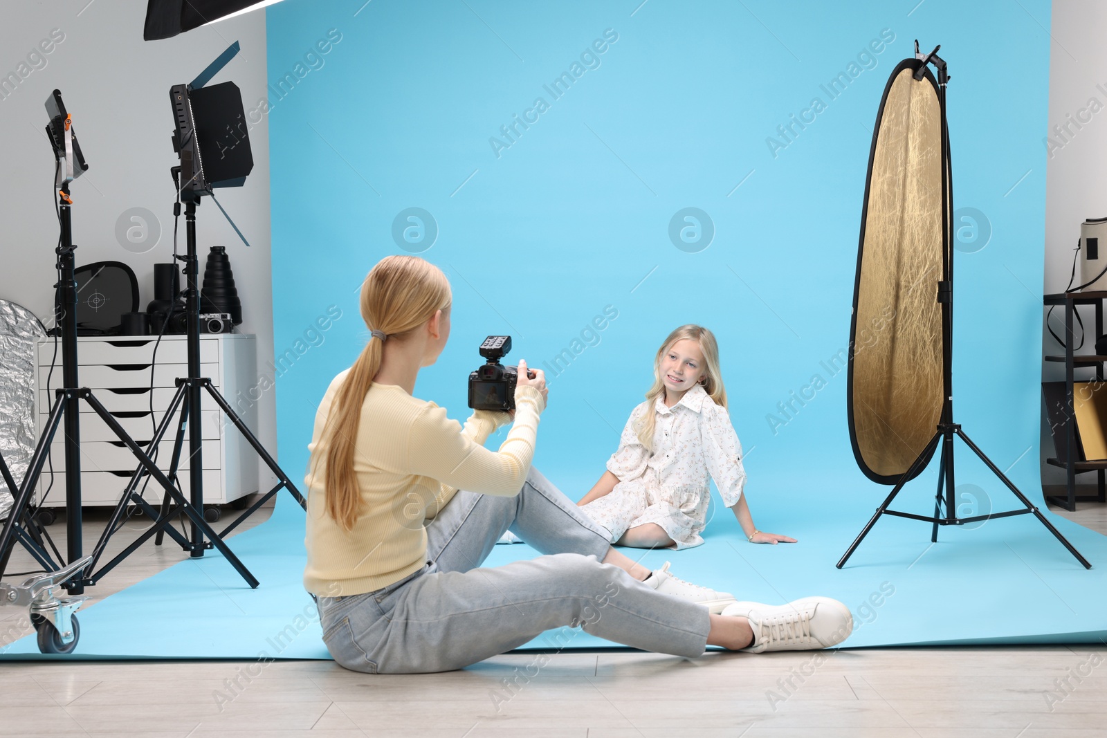 Photo of Photographer working with model in professional photo studio