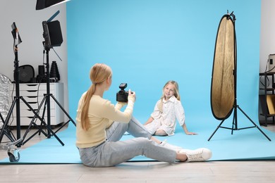 Photo of Photographer working with model in professional photo studio