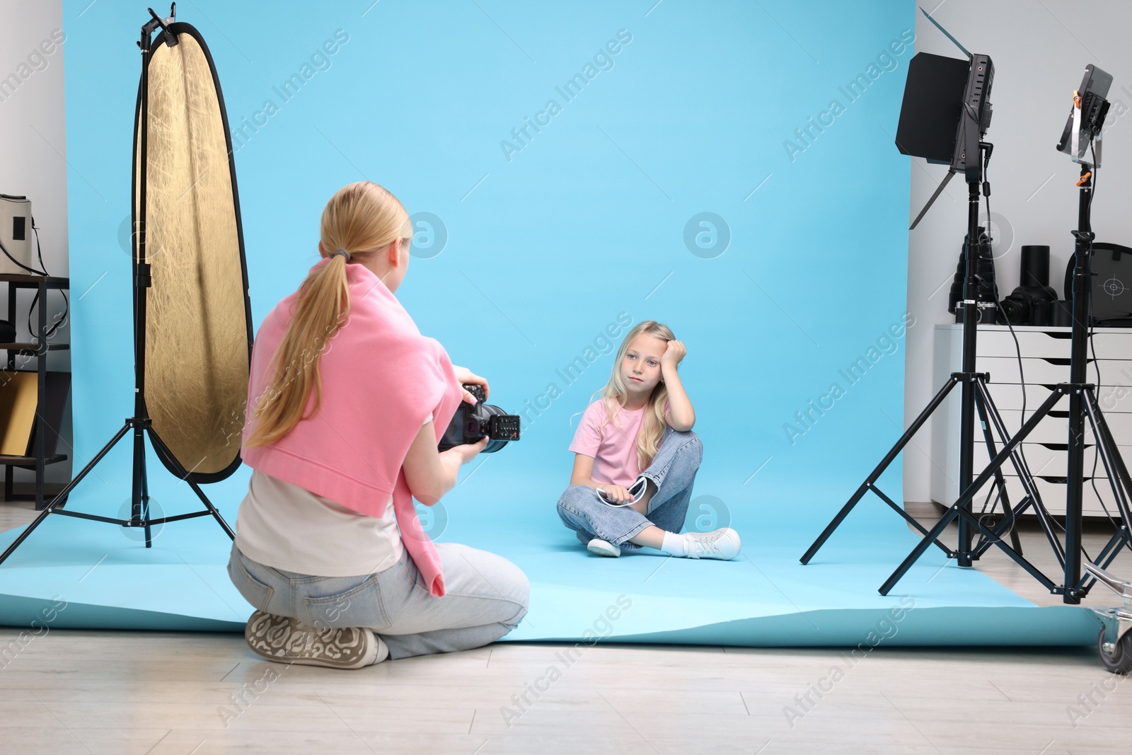 Photographer working with model in professional photo studio Photo of Photographer working with model in professional photo studio