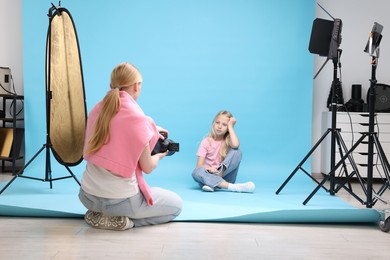Photo of Photographer working with model in professional photo studio