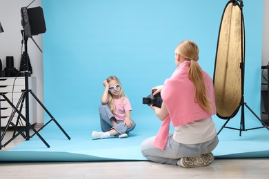 Photo of Photographer working with model in professional photo studio